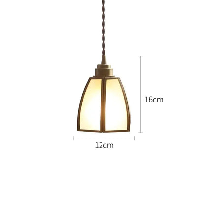A warm-toned modern brass glass copper led pendant light with geometric shade and twisted cord for dining room