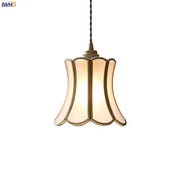 A warm-toned modern brass glass copper led pendant light with bell shape for dining room lighting