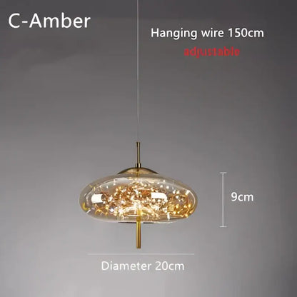Modern brass glass cord pendant light with gold-toned metal frame and clear glass shade filled with golden crystals