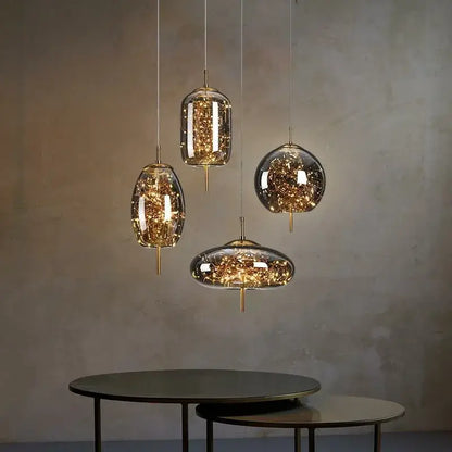 Set of modern brass glass cord pendant lights with golden led string design and iron finish for dining room use