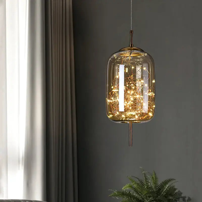 Modern brass glass cord pendant light with warm-toned fairy lights and iron finish, ideal for dining room use
