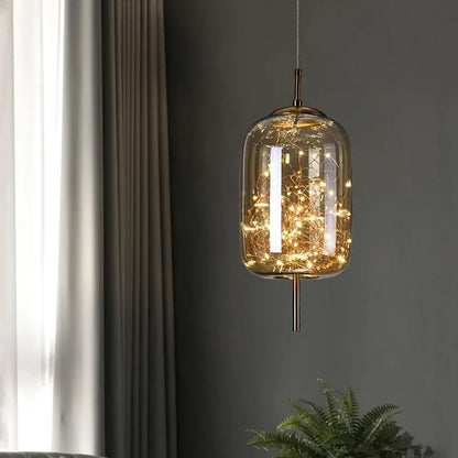 Modern brass glass cord pendant light with warm-toned fairy lights and iron finish, ideal for dining room use