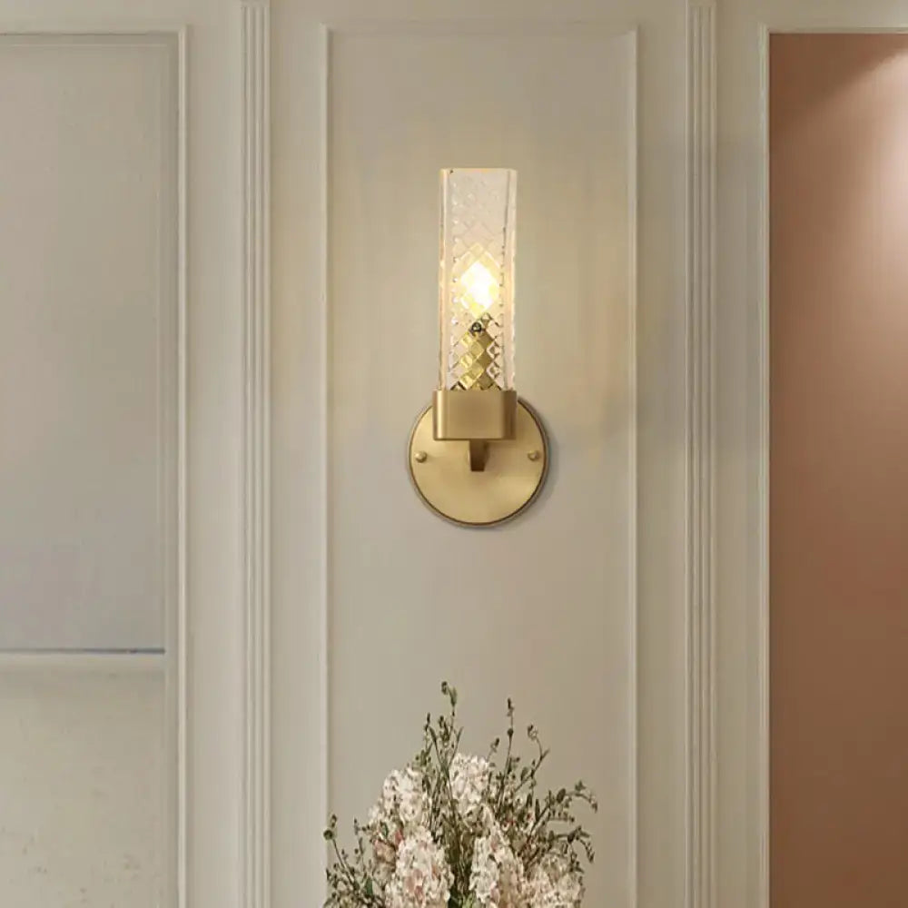 A sleek modern brass wall lamp with a clear textured glass cubic shade featuring e12 e14 light sockets