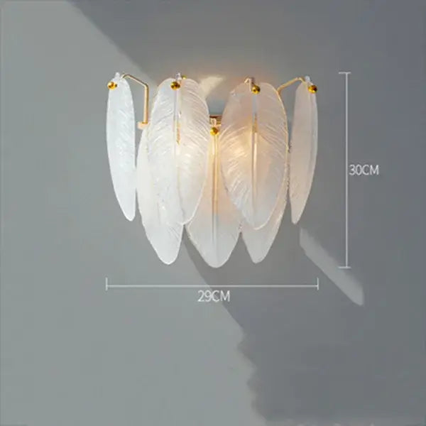 Elegant white feather chandelier wall sconce with gold-toned brass accents for modern dining room decor