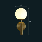 Modern brass glass globe wall mount light featuring a gold finish and frosted spherical glass for living room use