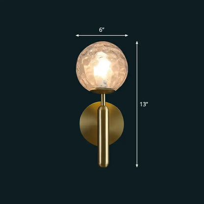 Modern brass glass globe wall mount light with gold-toned textured frosted globe and cylindrical stem for living room sconce