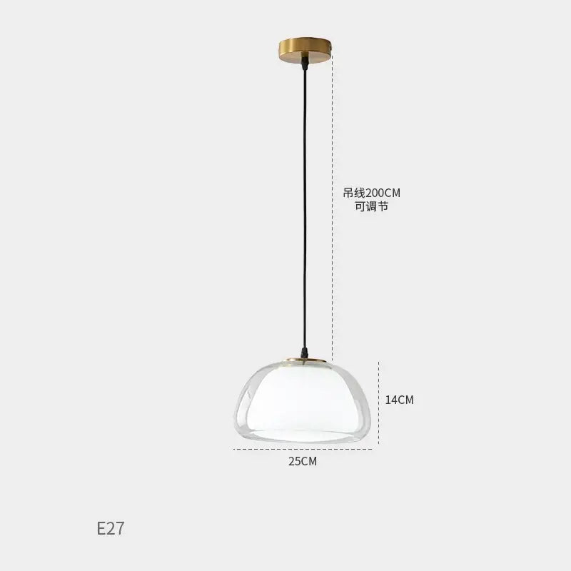 A modern brass decorbites glass jelly pendant lamp with a clear dome glass shade for dining room lighting