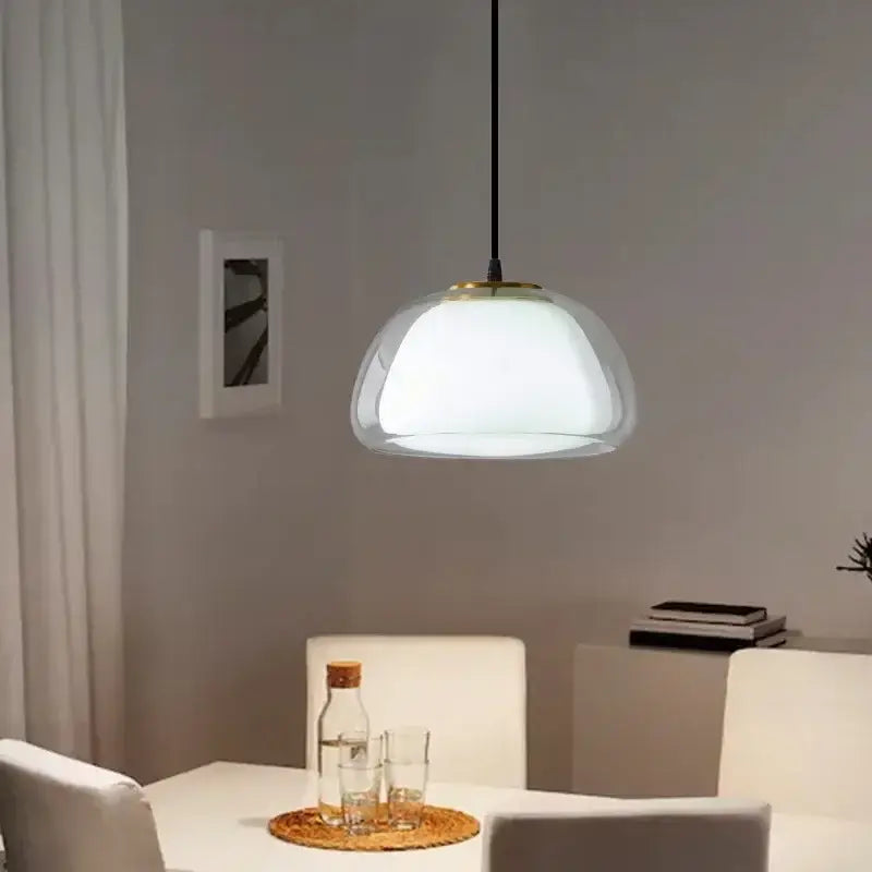 Modern brass glass jelly pendant lamp featuring a frosted glass dome with gold trim suspended by black cord decorbites pendant lamp