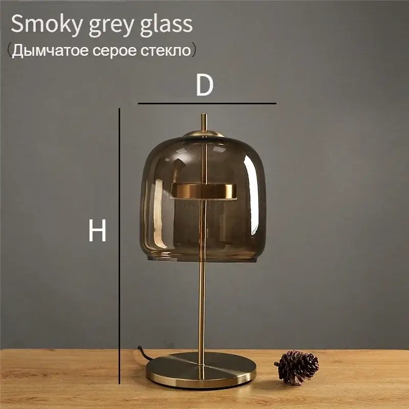 A modern brass glass lampshade led table lamp with smoky grey dome for elegant bedroom decor by decorbites
