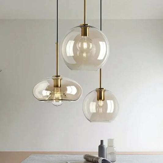 Modern brass glass pendant chandelier with hand-finished glass shades and warm bulbs for dining tables lighting