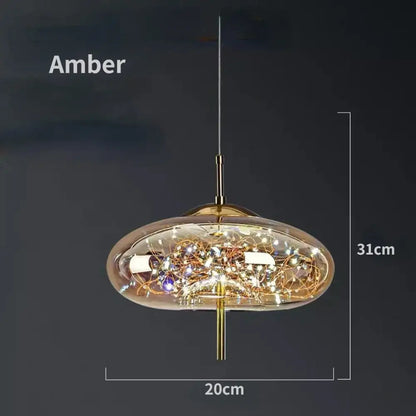 Modern brass glass pendant light featuring an amber-colored glass pendant with a golden metal frame and intricate wirework design