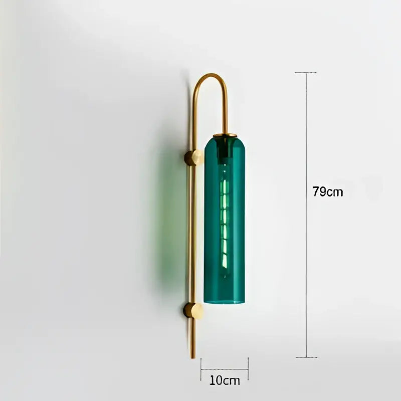 Modern brass glass sconce wall lamp with a tall translucent teal glass cylinder and polished metal arms for living room