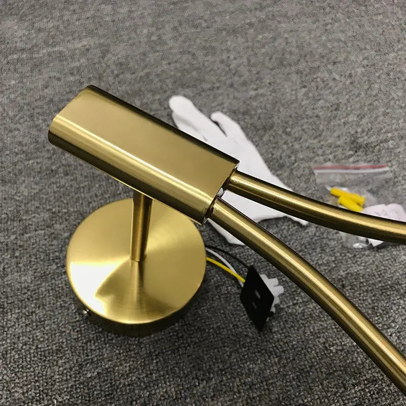 Modern brass glass wall lamp with gold-finished double-arm design for bedroom lighting by decorbites brass glass