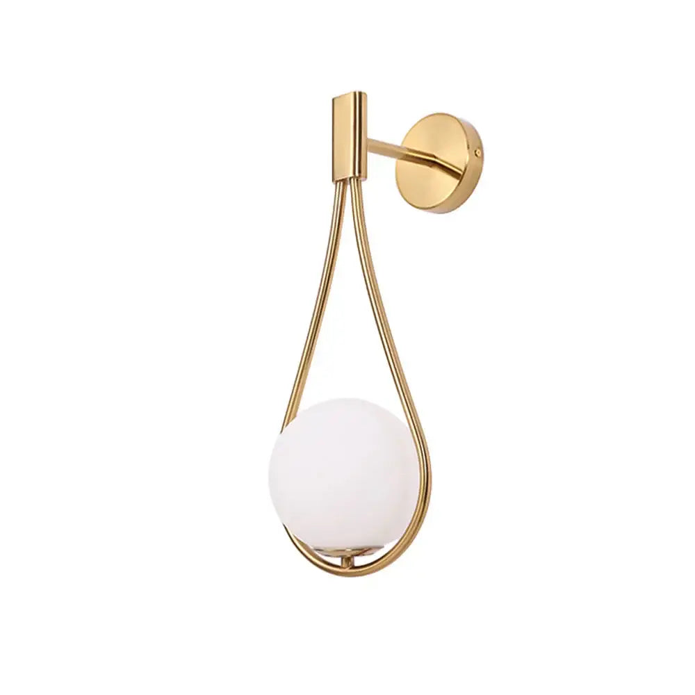 Modern brass glass wall lamp with gold-toned teardrop frame and frosted white spherical shade for bedroom lighting decorbites brass glass wall