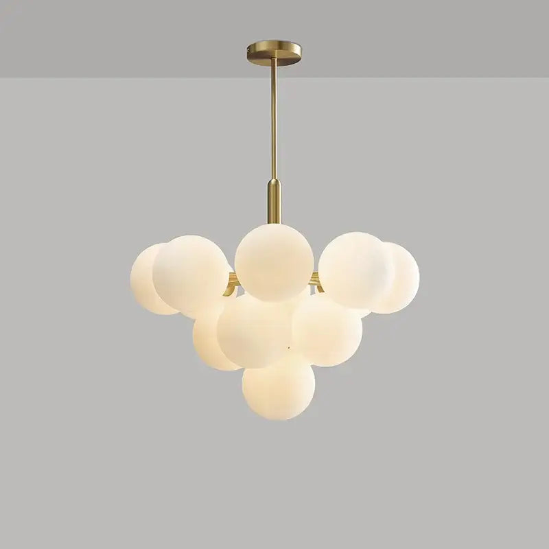 Modern brass globe pendant lamp with a metal frame and frosted glass cluster for dining room lighting