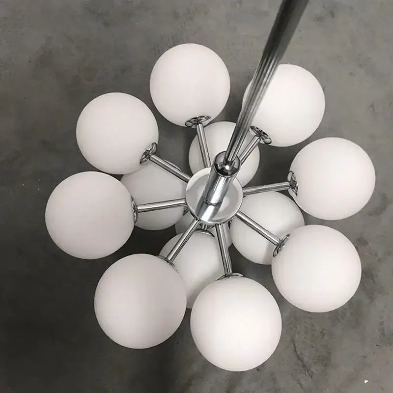 Modern chrome-finished globe pendant lamp with multiple frosted white glass globes for stylish dining room lighting