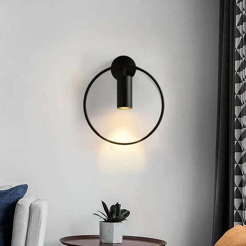 Black circular wall sconce with brass gold finish and adjustable led for warm ambient corridor lighting
