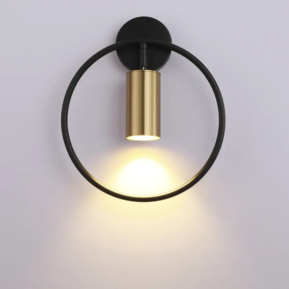 Modern brass gold adjustable led wall sconce with sleek black and gold cylindrical fixture for corridor lighting