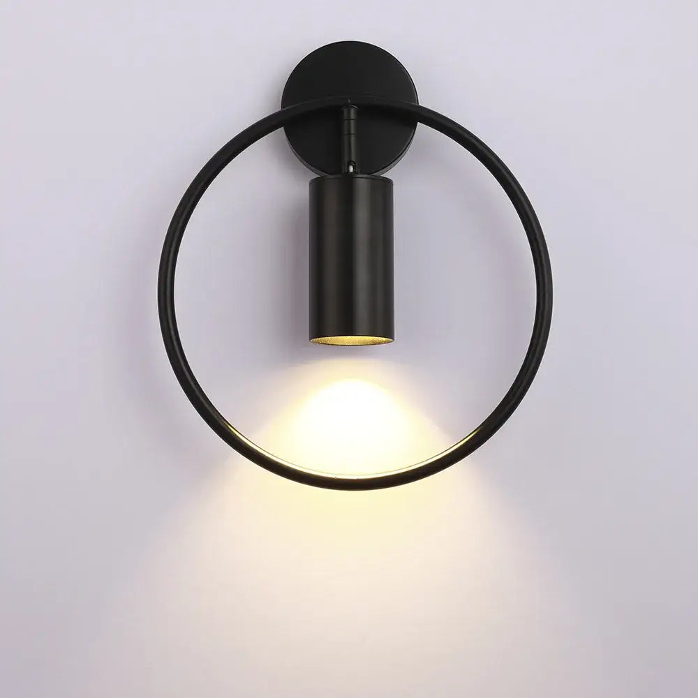 Black circular wall sconce with matte finish and illuminated cylindrical adjustable led brass gold fixture for corridor