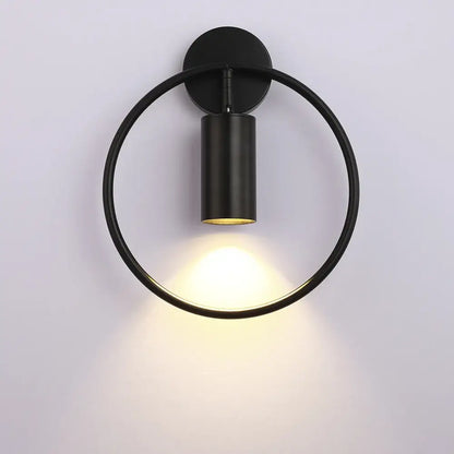 Black circular wall sconce with matte finish and illuminated cylindrical adjustable led brass gold fixture for corridor
