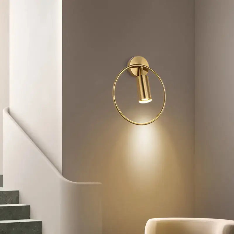Modern brass gold adjustable led wall sconce with a sleek minimalist circular design for corridor lighting