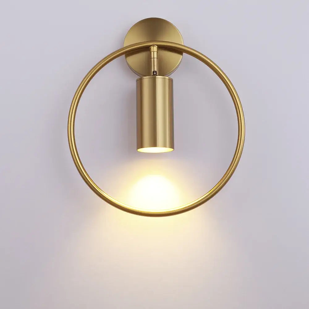 Modern brass gold adjustable led wall sconce with a circular base and sleek cylindrical light fixture for corridor use