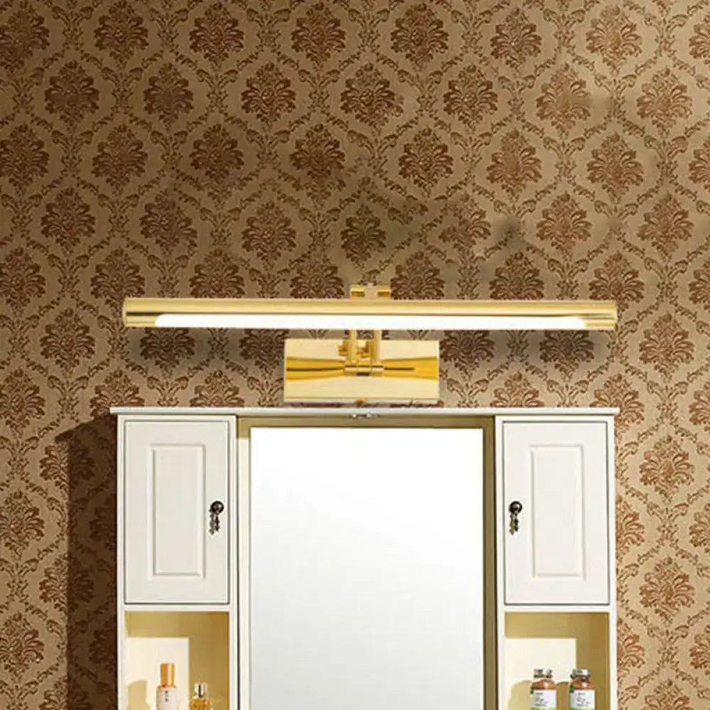 Modern brass gold finish rectangular wall lamp with tubular led design mounted above white mirrored bathroom vanity