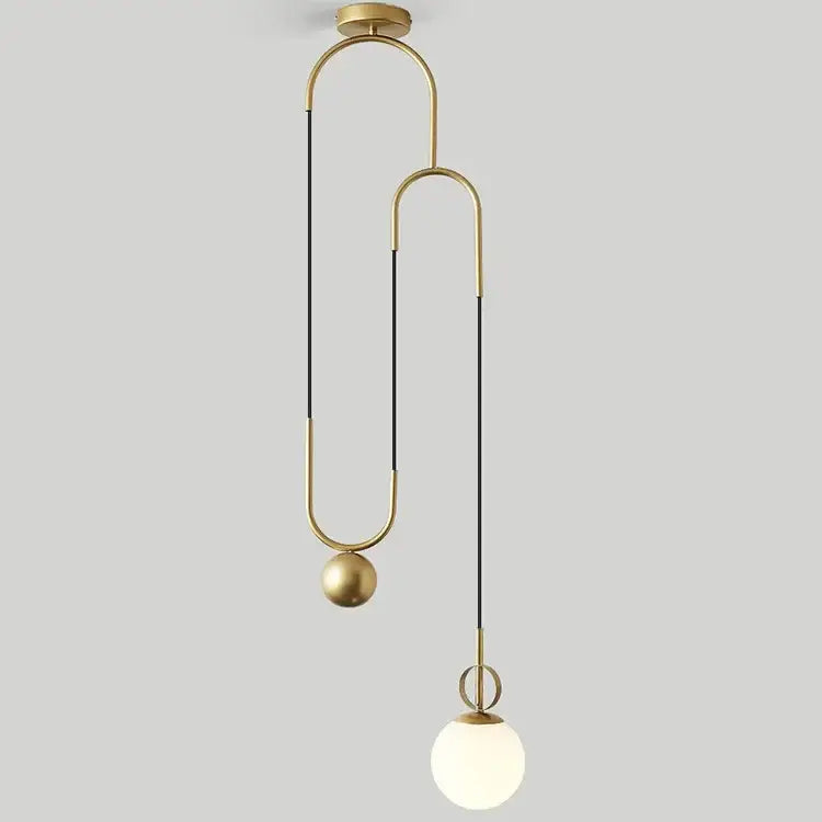 Modern brass golden glass ball pendant lamp with sleek curved metal arms and frosted globe bulb for bedroom decorbites golden glass