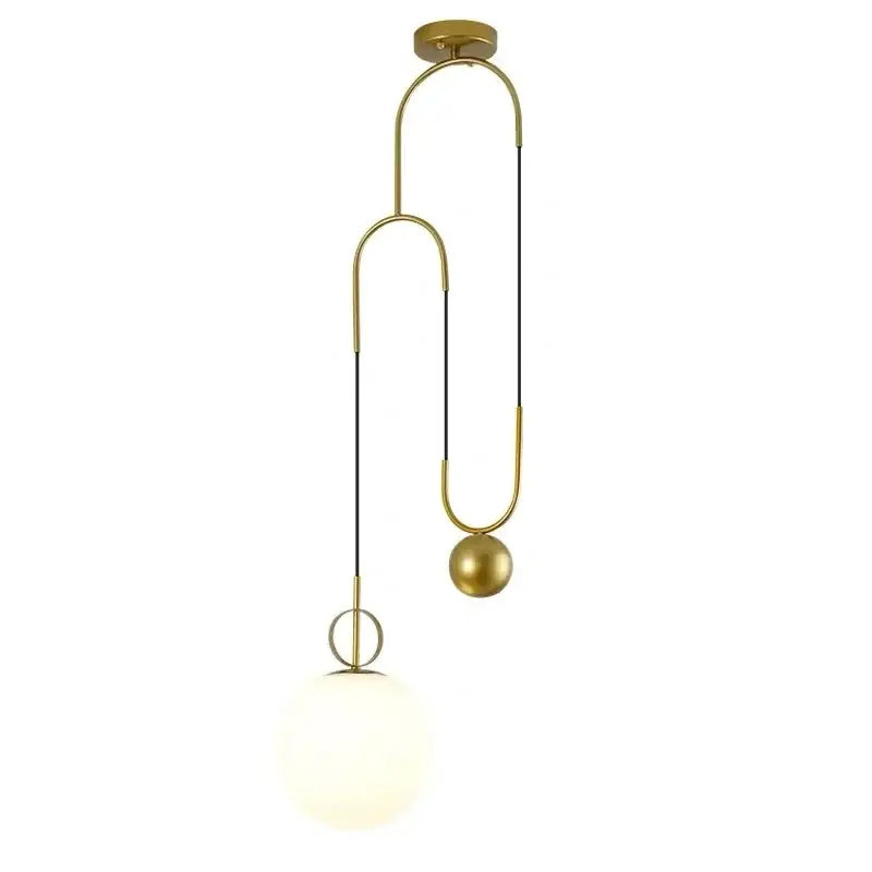 Modern brass golden glass ball pendant lamps with gold-toned curved metal frame and white opaque globe shade by decorbites
