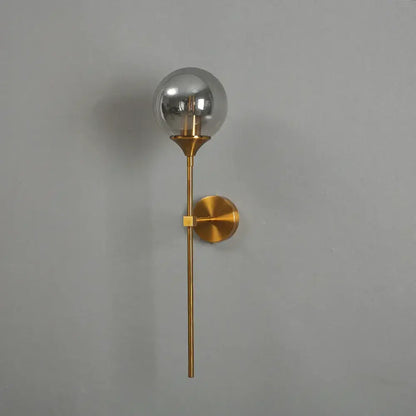 Modern brass golden glass ball wall lamp with clear globe and minimalist design for bedroom decorbites wall lamps
