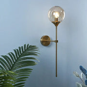 Modern brass golden glass wall sconce with spherical glass globe and exposed bulb for bedroom decorbites golden glass lighting
