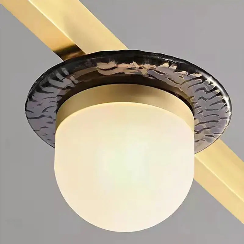 Modern brass gray glass led chandeliers featuring a frosted gray glass globe and textured black metal ring pendant light