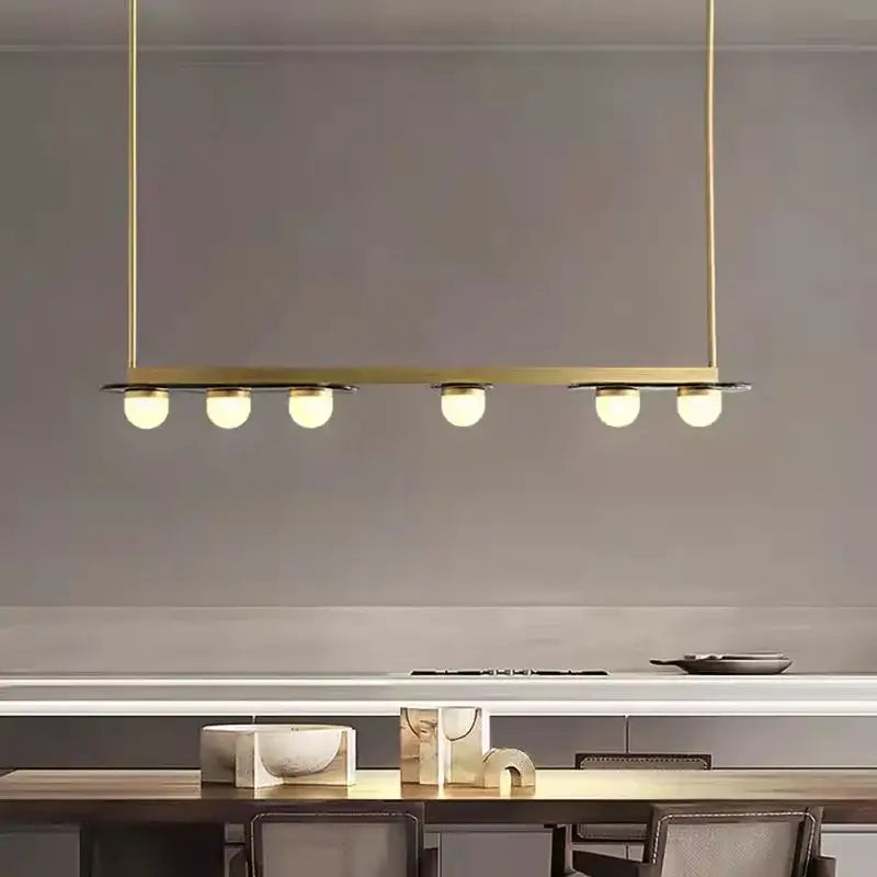 Modern brass gray glass led chandeliers with five spherical bulbs in a linear design for dining room pendant lighting