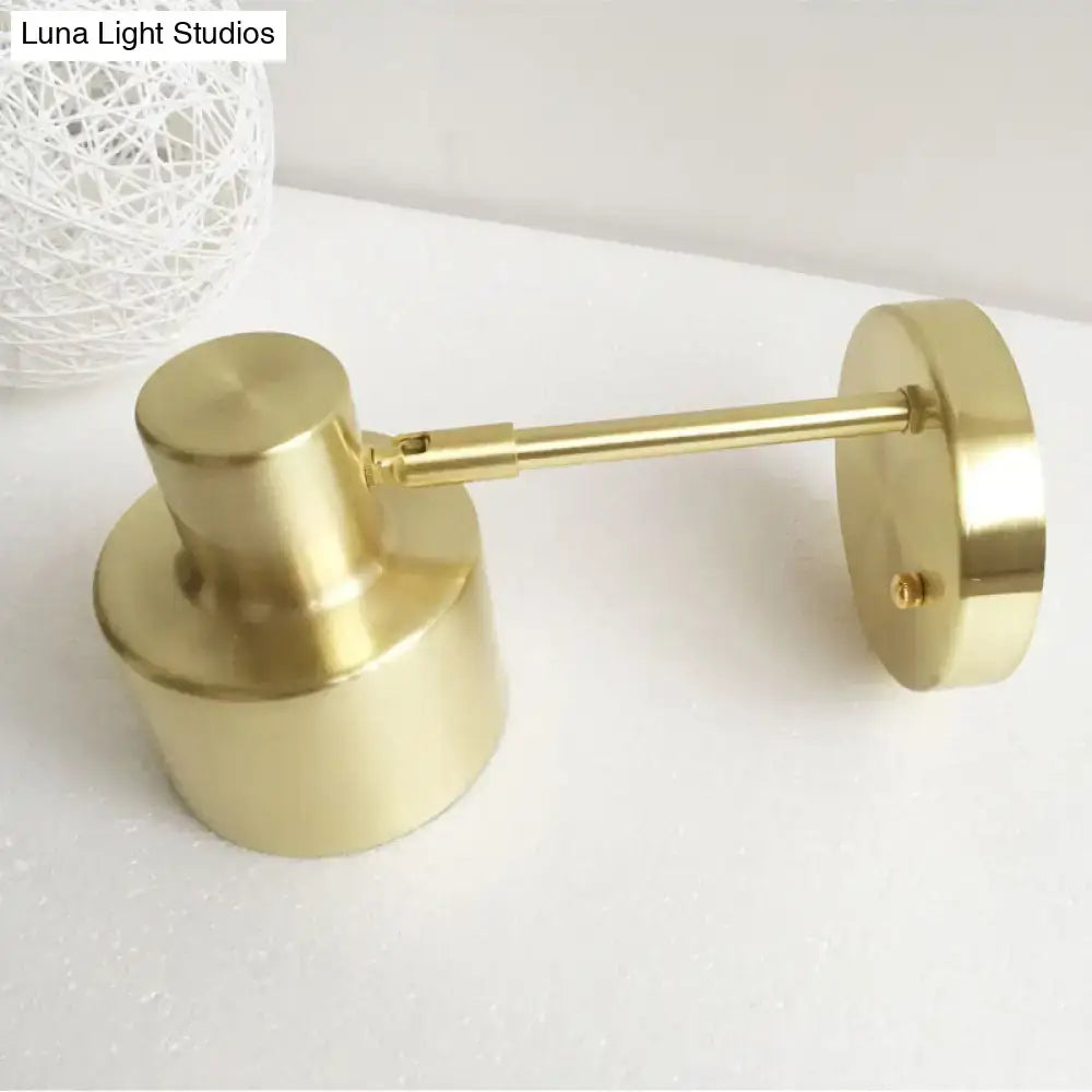 Brass-finished modern grenade shade wall light with cylindrical head and circular base for corridor wall use