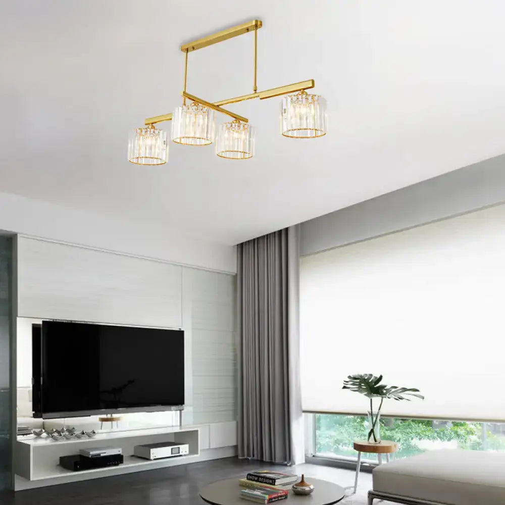 Modern brass hanging light with four clear glass shades and crystal accents for living room island lighting