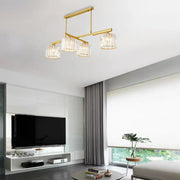 Modern brass hanging light with four clear glass shades and crystal accents for living room island lighting