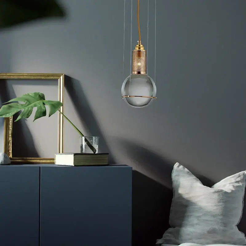 Modern brass honeycomb crystal ball led pendant light with frosted glass globe and brass mesh detailing for dining room decorbites crystal ball