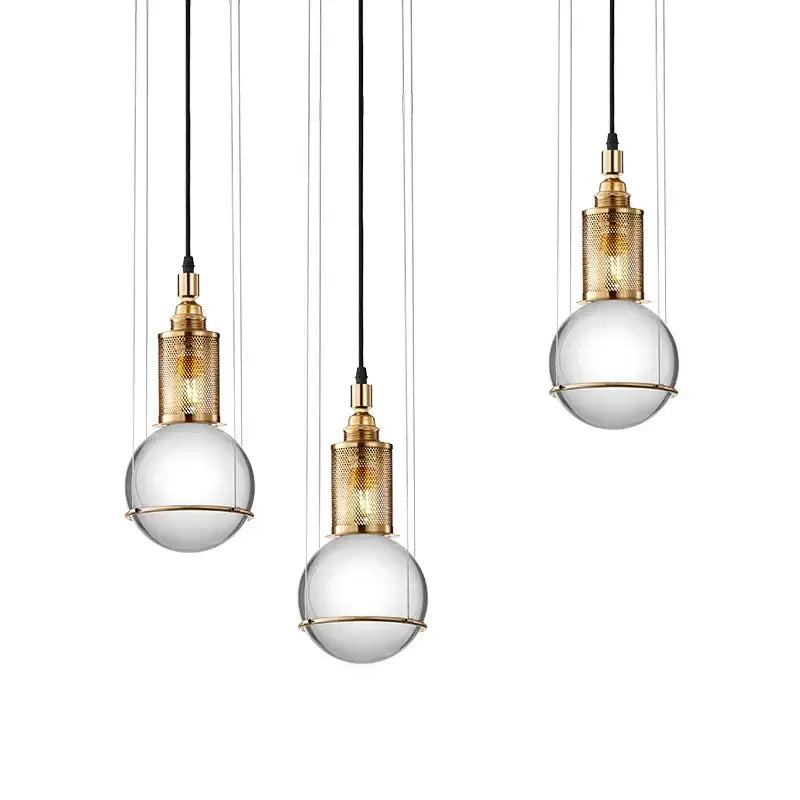 Three elegant brass pendant lights with clear glass globe shades and black cords for modern dining decorbites crystal ball led