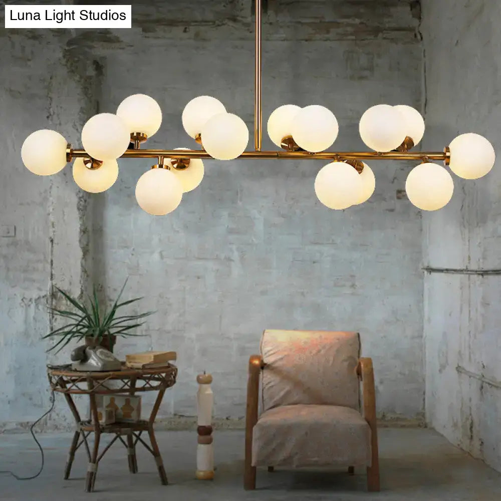 Modern brass chandelier featuring 16 frosted glass globes for elegant contemporary brass island lighting fixture use