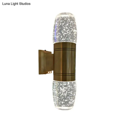 Modern brass led crystal wall sconce light featuring a clear glass bubble-effect design with bronze metallic band