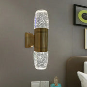 Modern brass led crystal wall sconce light with bubble glass sections and soft white light for bedroom use