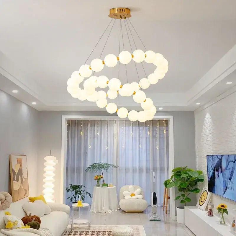 Modern brass led pendant light featuring frosted glass spheres suspended from a gold-toned fixture for living room decorbites brass led pendant