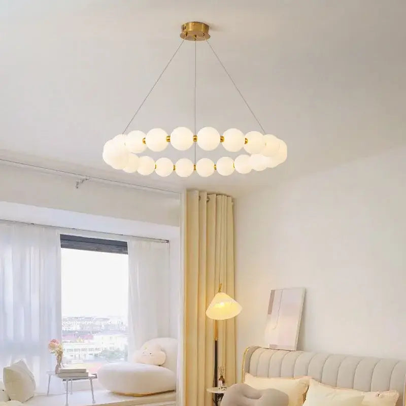 Modern brass led pendant light with gold-toned concentric rings and frosted glass spheres for living room decorbites brass led