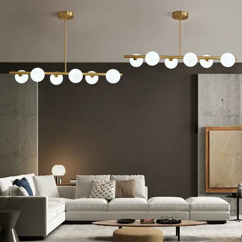 Modern brass led pendant lights with gold-toned metal and spherical white glass bulbs for dining room decorbites brass led chandelier