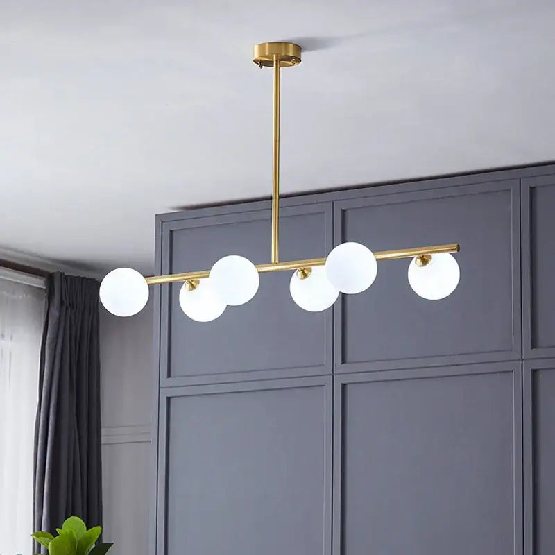 Modern brass led pendant lights featuring a gold-toned five globe frosted glass chandelier by decorbites brass led