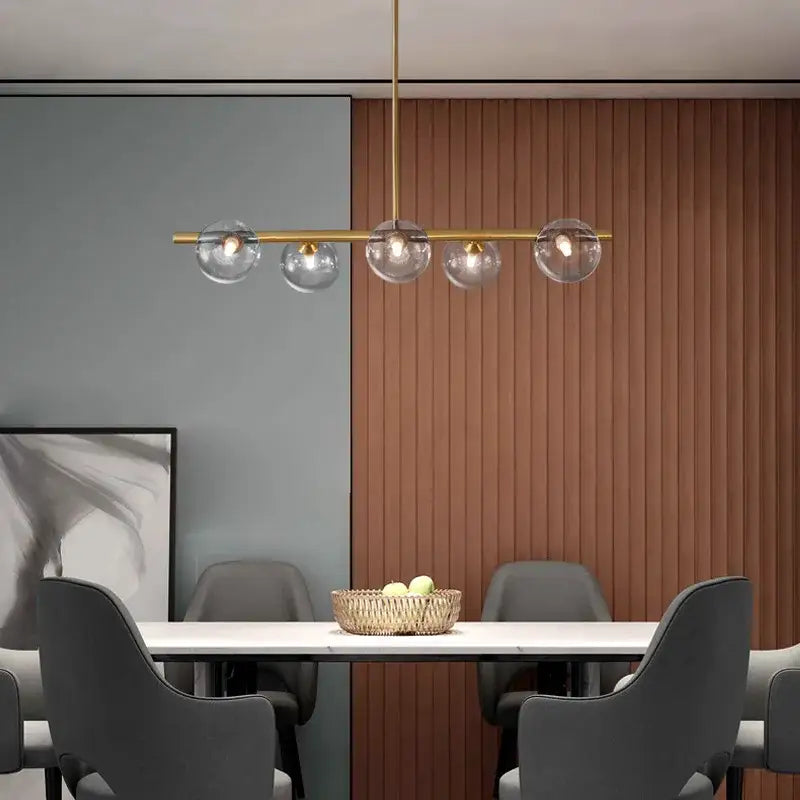 Modern brass led pendant lights with five clear glass globe shades for dining room decor by decorbites brass led pendants