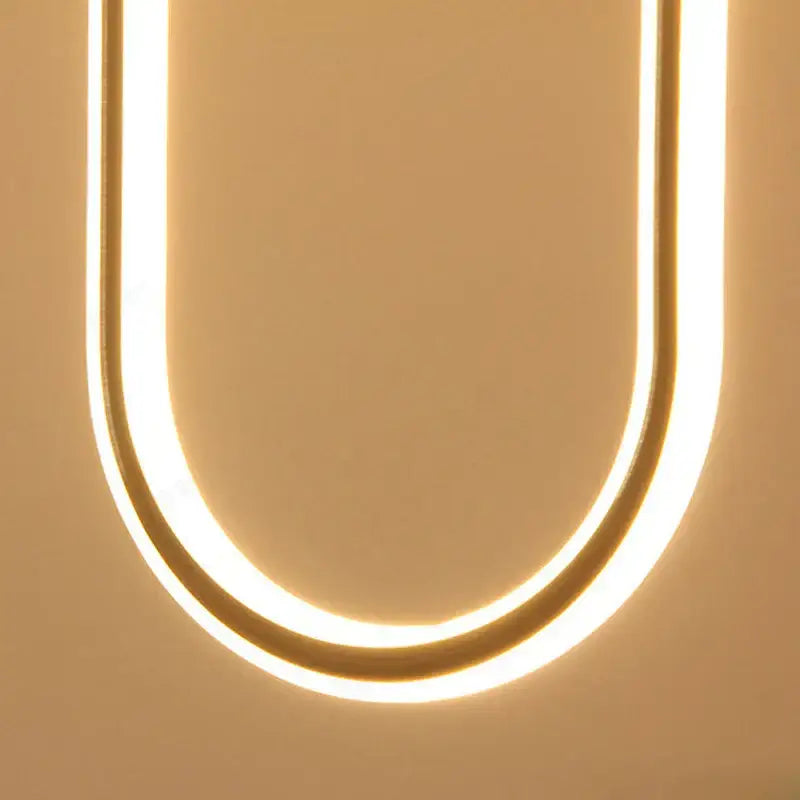 Modern brass led u-shaped bar chandelier with warm golden glow and smooth metallic frame for dining room light