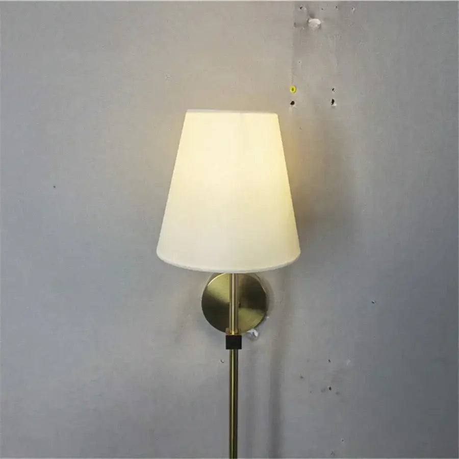 A sleek brass led wall sconce with a soft off-white fabric shade perfect for modern bedroom decorbites led wall decor