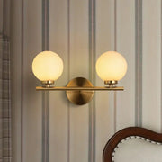 Modern brass light fixture bedroom sconce with frosted glass product shade and two product bulb globes