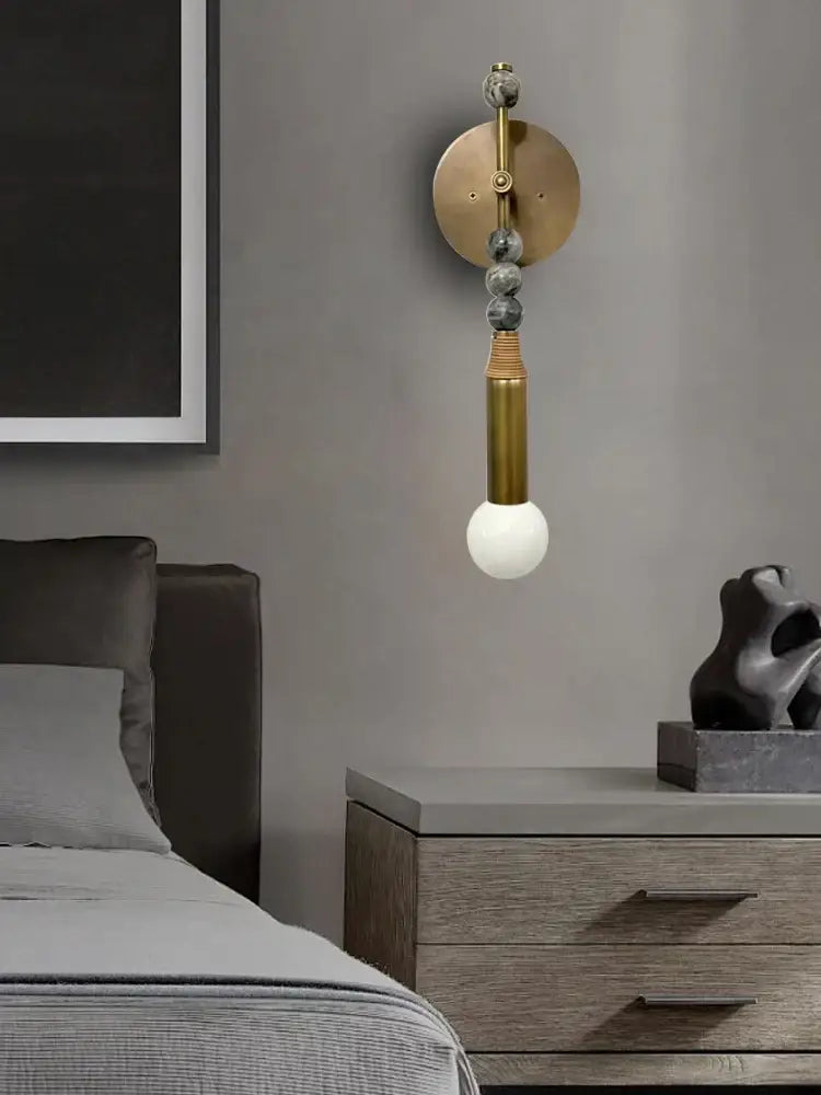 Modern brass marble ball wall sconce with circular backplate gray stone beads and exposed bulb for bedroom decorbites brass marble